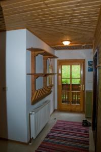 a hallway with wooden ceilings and a door and a rug at Lercherhof in Feld am See