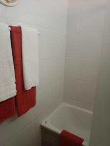 a bathroom with a tub and red and white towels at Sunset view in La Romantica, 1 in Los Realejos