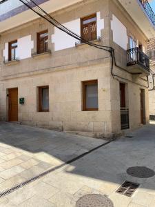 ceglany budynek z oknami i balkonem w obiekcie A de Maria - Tres Marias Apartments w mieście Redondela