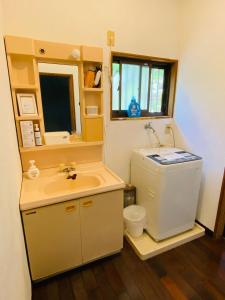 a bathroom with a sink and a toilet at Holiday Cottage BANSHIRO in Setouchi