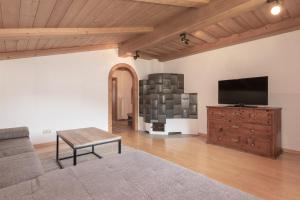 a living room with a flat screen tv and a couch at Flo's Apartment in Grossarl