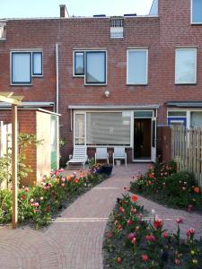 a brick building with a patio and flowers in front of it at Homestay Utrecht in Utrecht