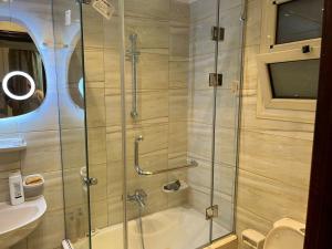 a shower with a glass door in a bathroom at Ghena in Cairo