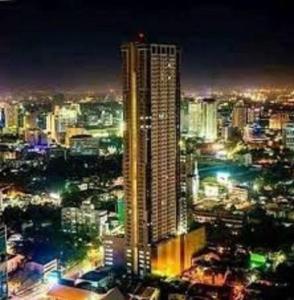 a lit up city at night with a tall building at Horizon 101 A2 Shortwalk Robinson Mall Mango Square Bar in Cebu City