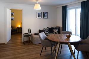 a living room with a table and a couch at Berg Lodge Gastein in Bad Hofgastein