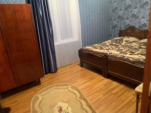 a bedroom with two beds and a rug on the floor at Guest house Mzia in Mazeri