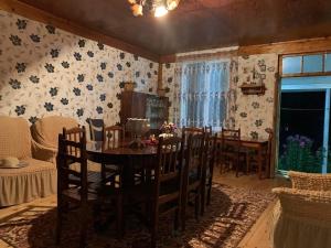 a dining room with a table and chairs at Guest house Mzia in Mazeri