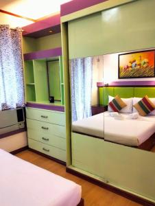 a bedroom with two beds and a large mirror at One Oasis A3 Shortwalk to Sm Mall - Free wifi in Davao City