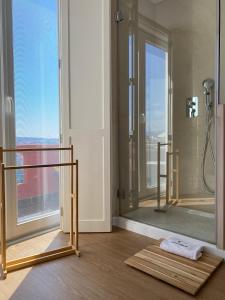 a bathroom with a shower with a glass door at Casa dos Carvalhos in Coimbra