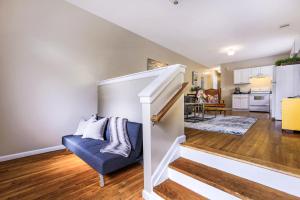 ein Wohnzimmer mit einer Treppe und einem blauen Sofa in der Unterkunft Spacious Historic Mid-City 2 Bedroom House!!! in New Orleans