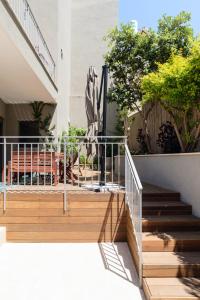 a set of stairs leading up to a house at Elegant Duplex with XL Patio by FeelHome in Tel Aviv