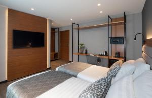 pokój hotelowy z 2 łóżkami i telewizorem z płaskim ekranem w obiekcie The Blend w mieście Nazaret