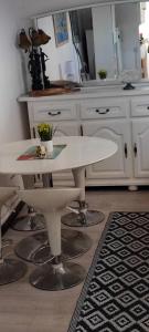 a kitchen with a white table and a counter at Maison charmante à Peille + jardin in Peille