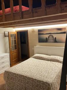 a bedroom with a bed and a picture of a castle at Il Vecchio Fienile in Millesimo