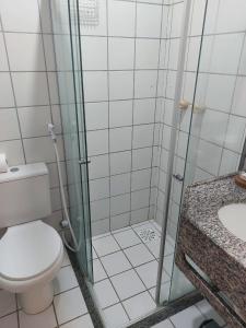 a bathroom with a shower and a toilet and a sink at Samba do Kite Pousada in Jericoacoara