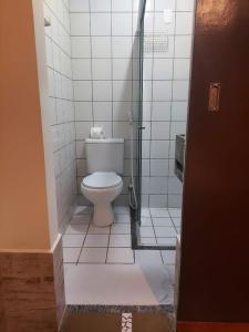 a bathroom with a toilet in a shower stall at Samba do Kite Pousada in Jericoacoara