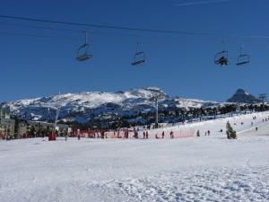 a group of people on a ski lift in the snow at Auberge de l'Étable in Montory