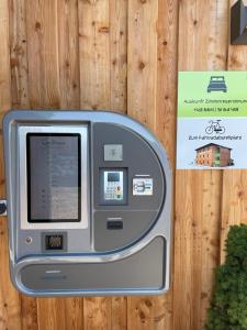 an atm machine in front of a wooden wall at Motel XL Lounge in Traisen +14 photos