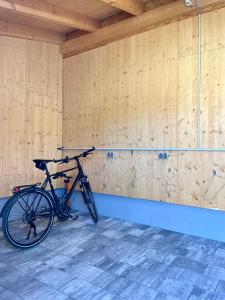a bike parked in a room with wooden walls at Motel XL Lounge in Traisen
