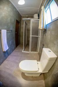 a bathroom with a toilet and a shower at Funk Bunks - Mount View Hostel in Kandy