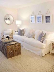 a white living room with a white couch and a table at Your Happy Place ON THE BEACH! in Key Colony Beach