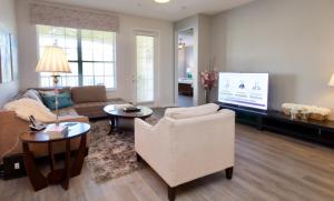 a living room with a couch and a tv at Vista Cay Luxury Retreat condo in Orlando