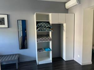 a room with a white bunk bed with shelves at Fleur de Lys - St Denis Providence GR - ONF in Saint-Denis +9 photos
