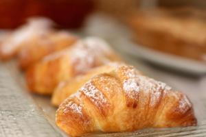 a group of pastries with powdered sugar on them at Agriturismo Antares in San Foca