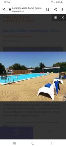 a website screenshot of a swimming pool with blue and white chairs at Chalet 47m2 dans PRL linge fourni in Gujan-Mestras