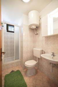 La salle de bains est pourvue de toilettes et d'un lavabo. dans l'établissement Apartments by the sea Petrcane, Zadar - 3285, à Petrčane