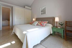 a bedroom with a bed and a table with a lamp at Villa Blue Marlin 8 in Pasito Blanco