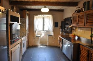 a kitchen with a window and a sink and a counter at Agriturismo B&B Luna di Quarazzana in Fivizzano Tuscany in Fivizzano