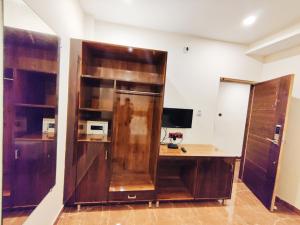 an office with a wooden desk and a computer at Namaste Benares Varanasi in Varanasi