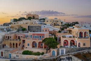 a view of a village at sunset at Coat of Arms Mansion in Fira