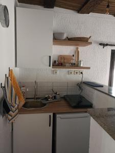 a kitchen with a sink and a counter top at Poljoprivredno turističko domaćinstvo Degurić in Valjevo +20 photos