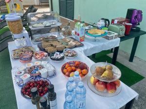 a table topped with plates of food and bottles of water at B&b Villa Asia in Sulmona