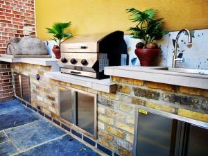 a outdoor kitchen with a stove and a sink at King Suite In 600 Year Old Manor House In Saffron Walden North Essex in Saffron Walden