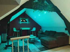 a living room with a couch and a table at Côté spa in Noyelles-sous-Lens
