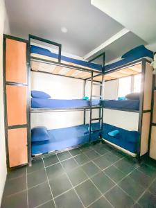 a room with two bunk beds in it at Black Sand Beachhouse in Monterrico