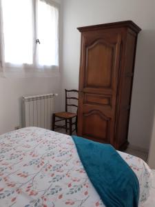 a bedroom with a bed and a wooden cabinet at Bompastor in Bompas