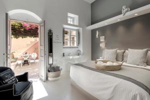 a bedroom with a large bed with a basket on it at Coat of Arms Mansion in Fira +98 photos