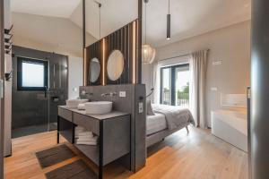 a bathroom with a bed and a sink and mirror at Villa Bewegte Berge in Kaštelir +56 photos
