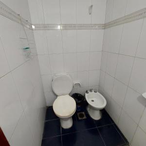 a white bathroom with a toilet and a bidet at El apartamento de Teddy in San Miguel de Tucumán +29 photos