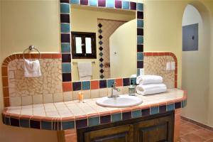 a bathroom with a sink and a mirror at HACIENDA MONARCAS Resort in Puerto Peñasco