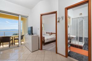 a room with a door open to a bedroom with a view at Apartment Igor in Ičići