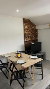 a dining room with a wooden table and chairs at Logements au dessus du Bois de l Ours Les Rousses in Les Rousses