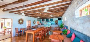 a dining room with a wooden table and chairs at Ananda Beach Hotel in Paje