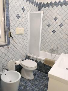 a bathroom with a white toilet and a sink at Domus Cornelia in Naples