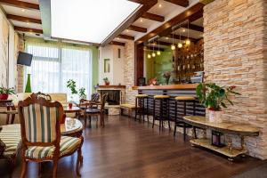 a restaurant with a bar and some chairs and tables at Casa Freya in Buşteni