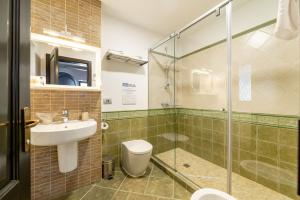a bathroom with a shower and a sink and a toilet at Casa Freya in Buşteni +124 photos